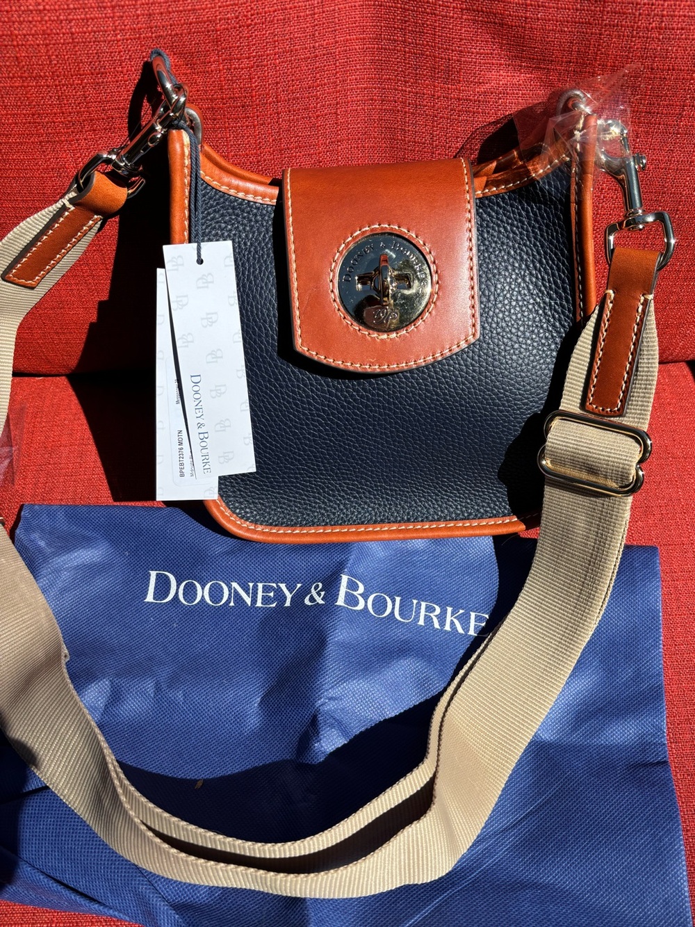 Dooney & Bourke midnight blue with Brown Trim Pebbled Leather Messenger bag.
